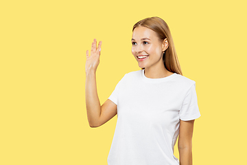 Image showing Caucasian young woman\'s half-length portrait on yellow background