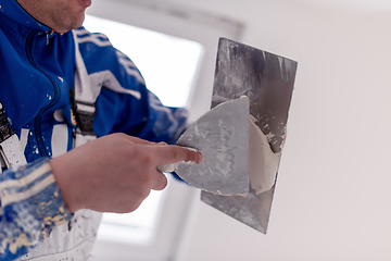 Image showing construction worker plastering on gypsum walls