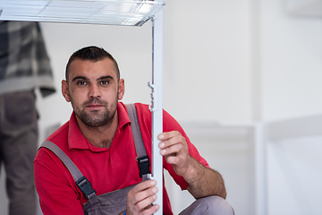 Image showing worker installing a new kitchen