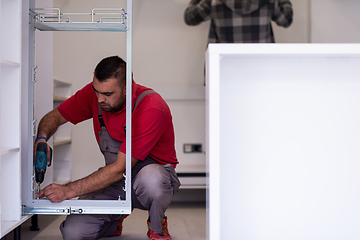 Image showing workers installing a new kitchen