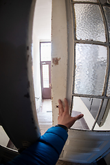 Image showing man opening door of a building