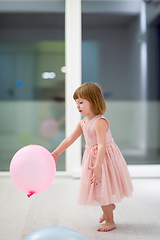 Image showing cute little girl playing with balloons