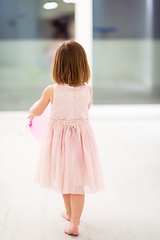 Image showing cute little girl playing with balloons