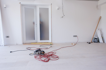 Image showing carpenters installing glass door with a wooden frame