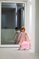 Image showing cute little girl playing with balloons