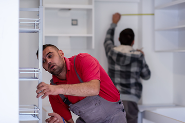 Image showing workers installing a new kitchen