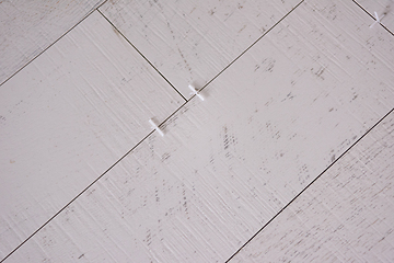 Image showing Ceramic wood effect tiles and tools for tiler on the floor