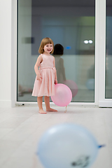 Image showing cute little girl playing with balloons