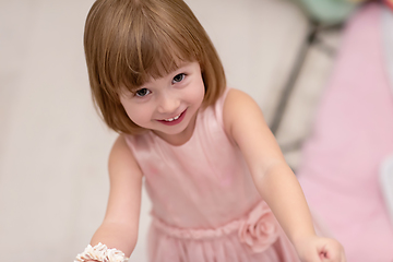 Image showing little girl enjoying while playing with mother\'s jewelry