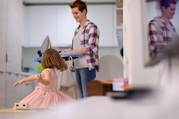 Image showing mother and little daughter spending time together at home