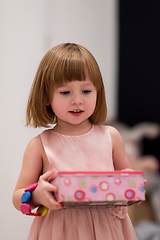 Image showing little girl enjoying while playing with mother\'s jewelry