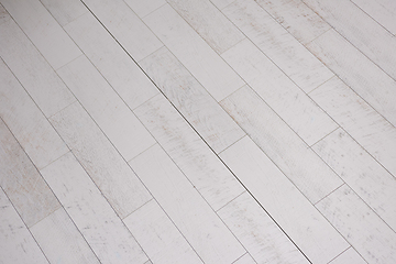 Image showing Ceramic wood effect tiles and tools for tiler on the floor