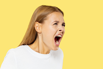 Image showing Caucasian young woman\'s half-length portrait on yellow background