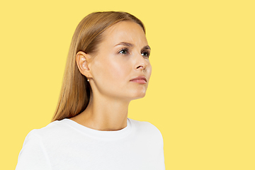 Image showing Caucasian young woman\'s half-length portrait on yellow background