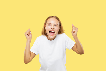 Image showing Caucasian young woman\'s half-length portrait on yellow background