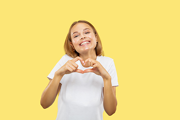 Image showing Caucasian young woman\'s half-length portrait on yellow background