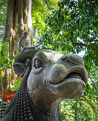 Image showing Monkey on a cow statue in the Monkey Forest, Ubud, Bali, Indones