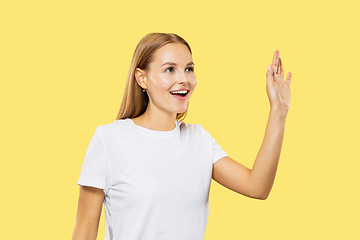 Image showing Caucasian young woman\'s half-length portrait on yellow background