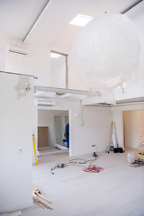 Image showing carpenters installing glass door with a wooden frame