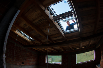 Image showing construction worker installing roof window