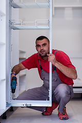 Image showing worker installing a new kitchen