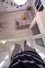 Image showing man standing upstairs on glass floor