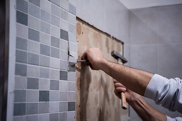 Image showing worker remove demolish old tiles in a bathroom