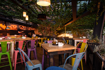 Image showing blurred people in cafe decorate with hanging plant