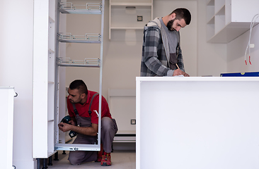 Image showing workers installing a new kitchen