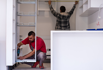 Image showing workers installing a new kitchen