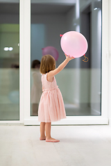 Image showing cute little girl playing with balloons