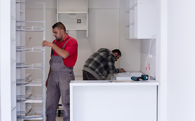 Image showing workers installing a new kitchen