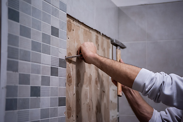 Image showing worker remove demolish old tiles in a bathroom