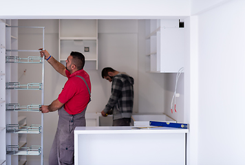 Image showing workers installing a new kitchen