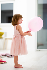 Image showing cute little girl playing with balloons