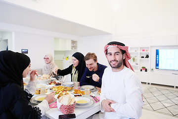 Image showing young arabian man having Iftar dinner with muslim family