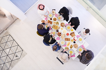 Image showing traditional muslim family praying before iftar dinner top view