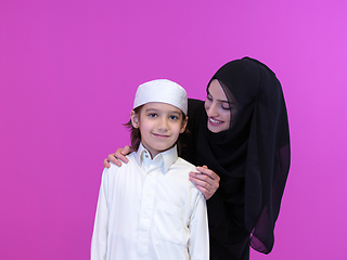 Image showing portrait of muslim mother and son on pink background