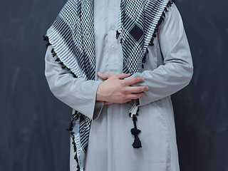 Image showing portrait of arabian man in front of black chalkboard