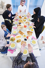 Image showing traditional muslim family praying before iftar dinner