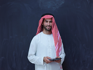 Image showing young arabian muslim businessman using tablet computer