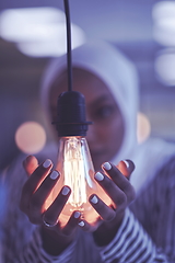 Image showing internet of things concept woman holding hands around bulb