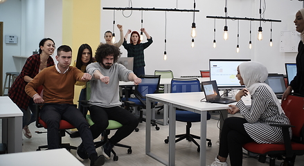 Image showing racing on office chairs