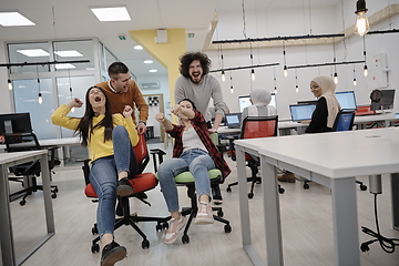 Image showing racing on office chairs