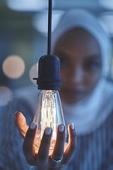 Image showing internet of things concept woman holding hands around bulb