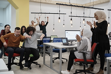 Image showing racing on office chairs