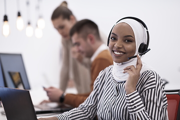 Image showing African businesswoman wearing headset in helpdesk