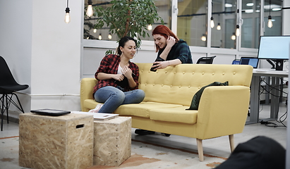 Image showing female friends discussion about project at office