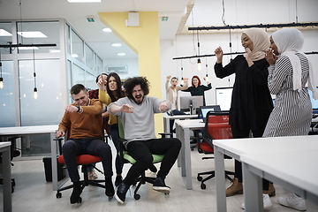 Image showing racing on office chairs