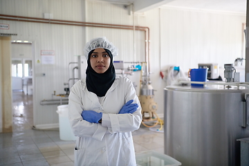 Image showing African black muslim business woman in local cheese production company